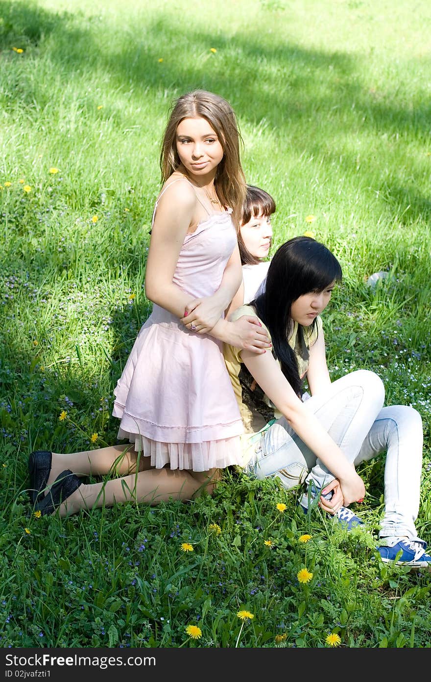 Three girls sitting on grass