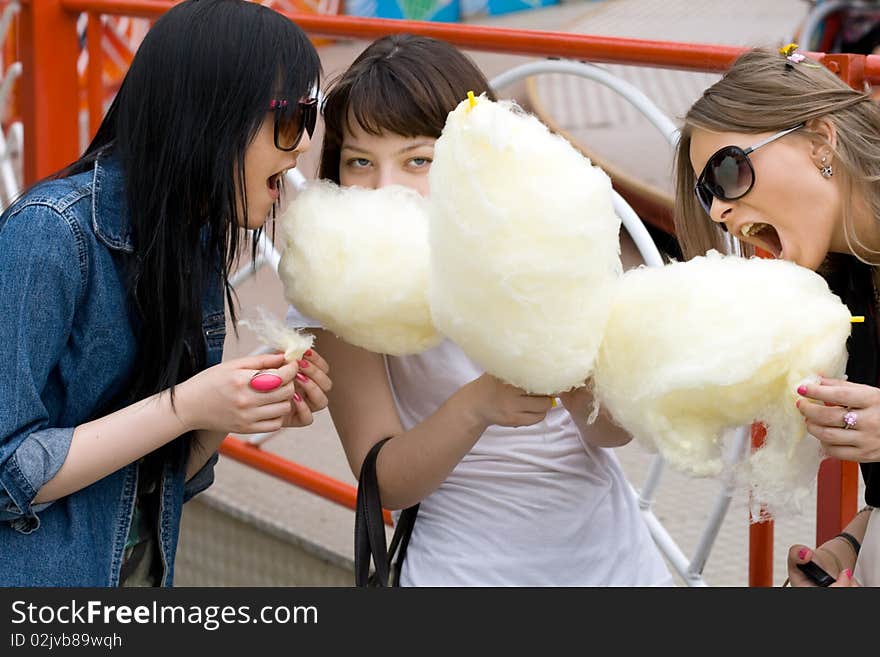 Three girls eating candy floss