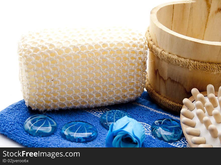 Massage sponge on blue towel and stones. Massage sponge on blue towel and stones