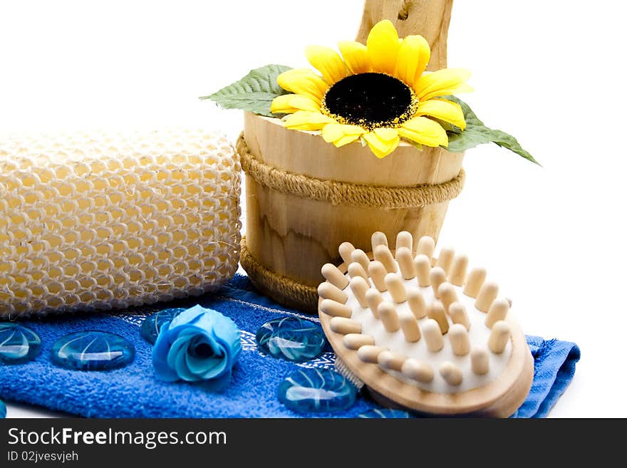 Massage sponge on blue towel and brush