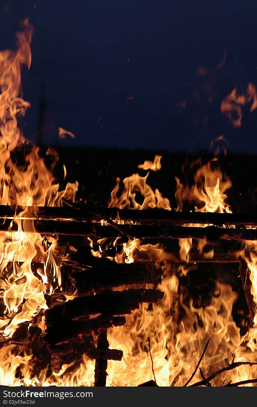 Uncontrolled fire against the dark background. Uncontrolled fire against the dark background