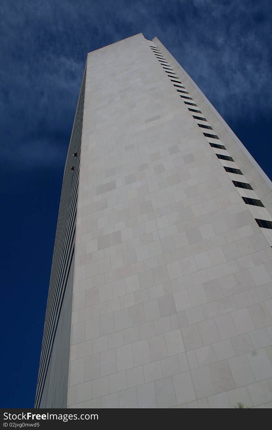 Two peple going up on a  very tall building in Miami