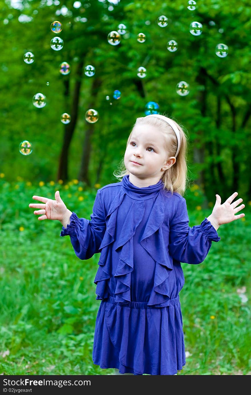 Little girl in park with bubbles. Outdoor shot. Little girl in park with bubbles. Outdoor shot