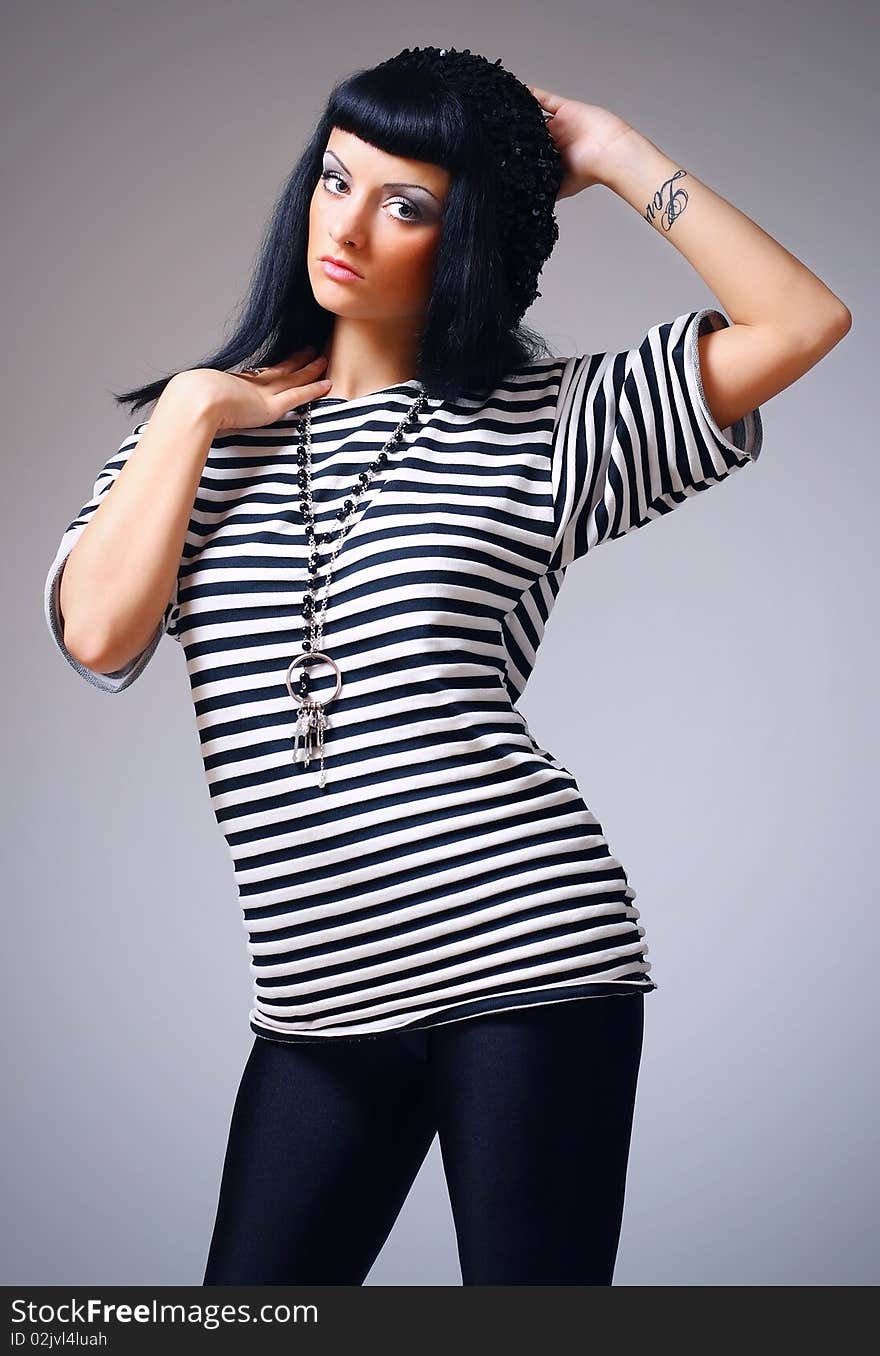 Attractive fashion woman posing in a striped top