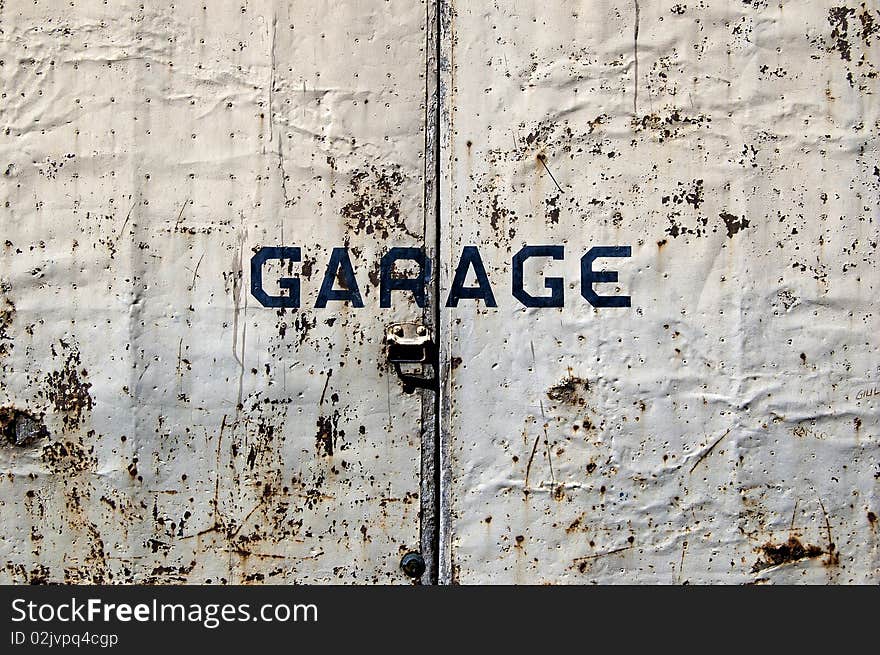 A rusted old door of a garage. A rusted old door of a garage