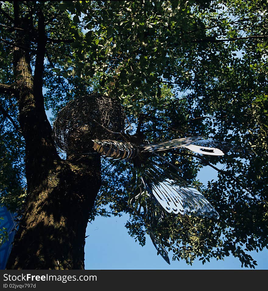 A big metal butterfly hung on the tree