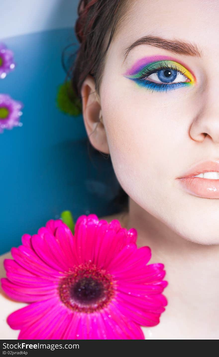 Young pretty girl with a pink flower. Young pretty girl with a pink flower