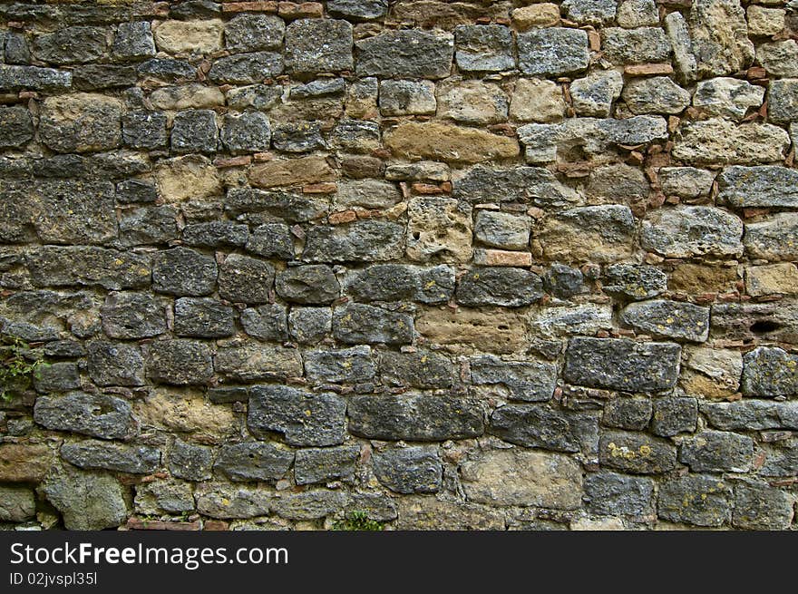 A wall of aged stones in line. A wall of aged stones in line