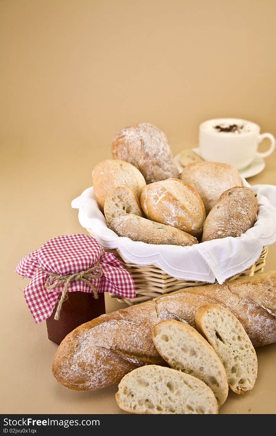 Assortment of bread with jam and coffee against a beige background. Assortment of bread with jam and coffee against a beige background.