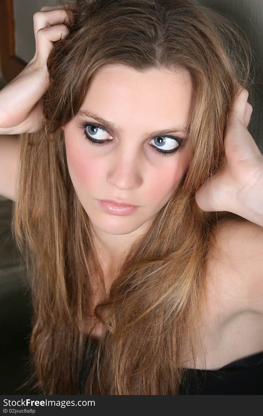 Beautiful female model with blue eyes and dark make up