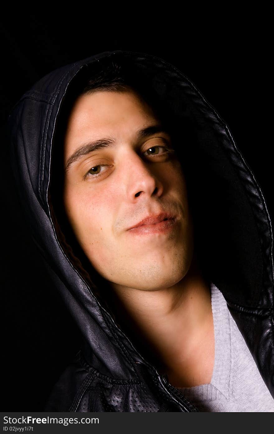 Portrait of a handsome young man on black background