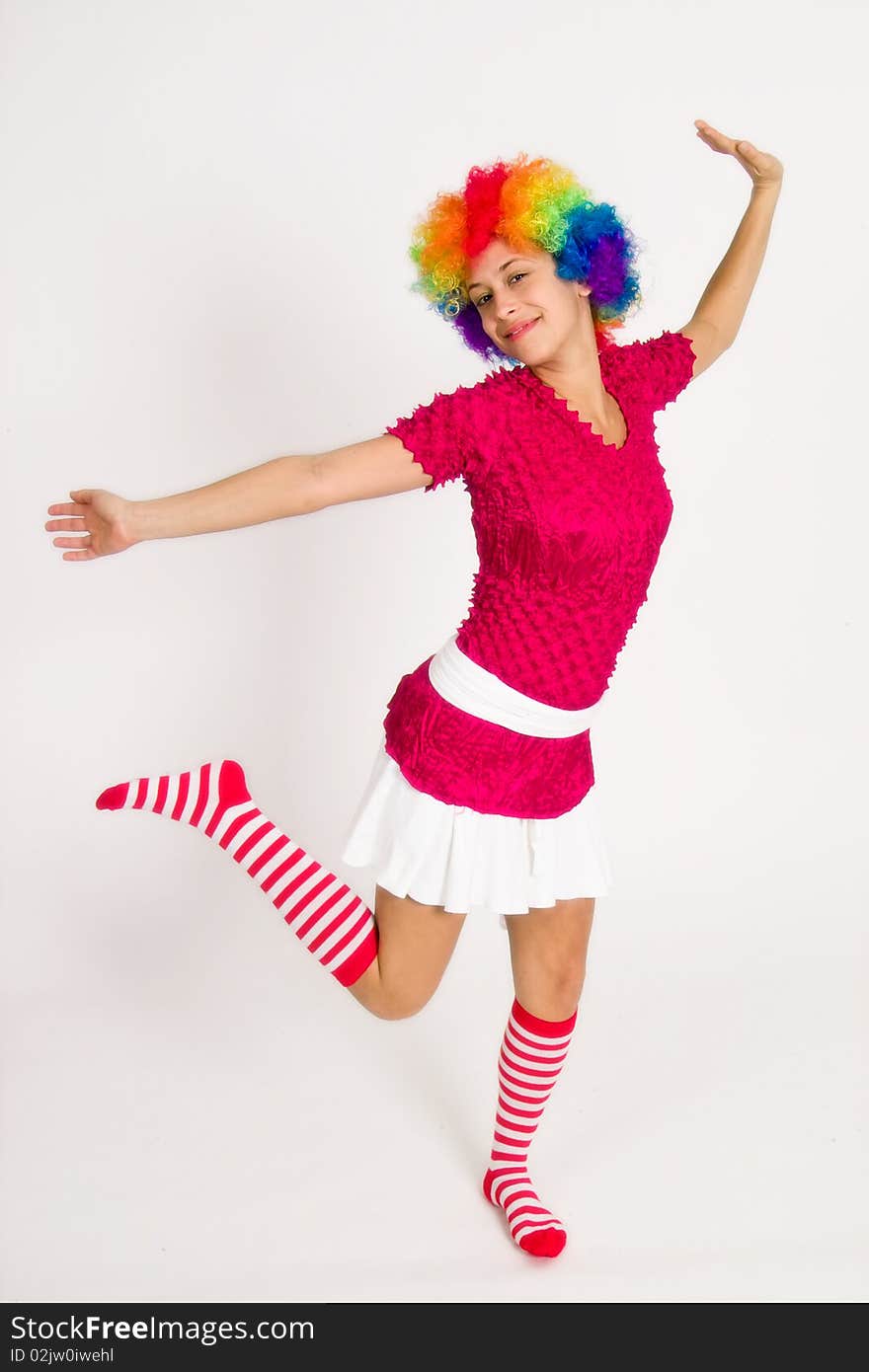 A portrait of a girl in a clown wig, posing playfully. A portrait of a girl in a clown wig, posing playfully