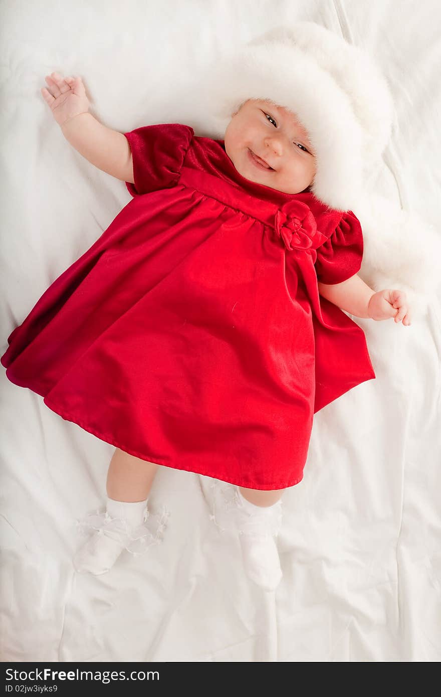 Cute baby girl in beautiful red dress