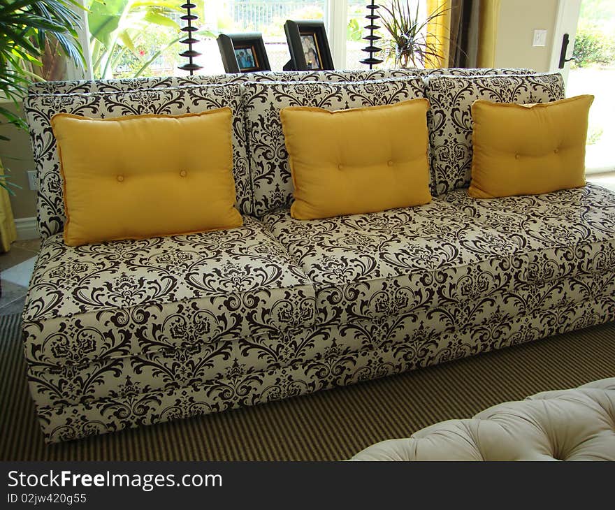 Beautiful black and white couch or sofa with three yellow gold pillows. Beautiful black and white couch or sofa with three yellow gold pillows