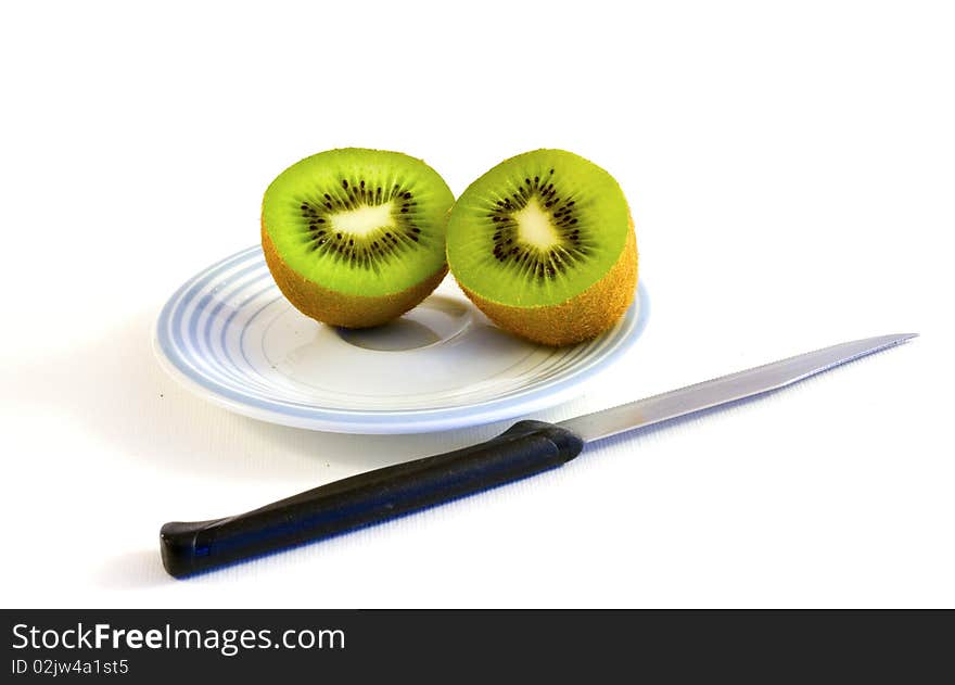 Kiwi sliced on a plate with knife