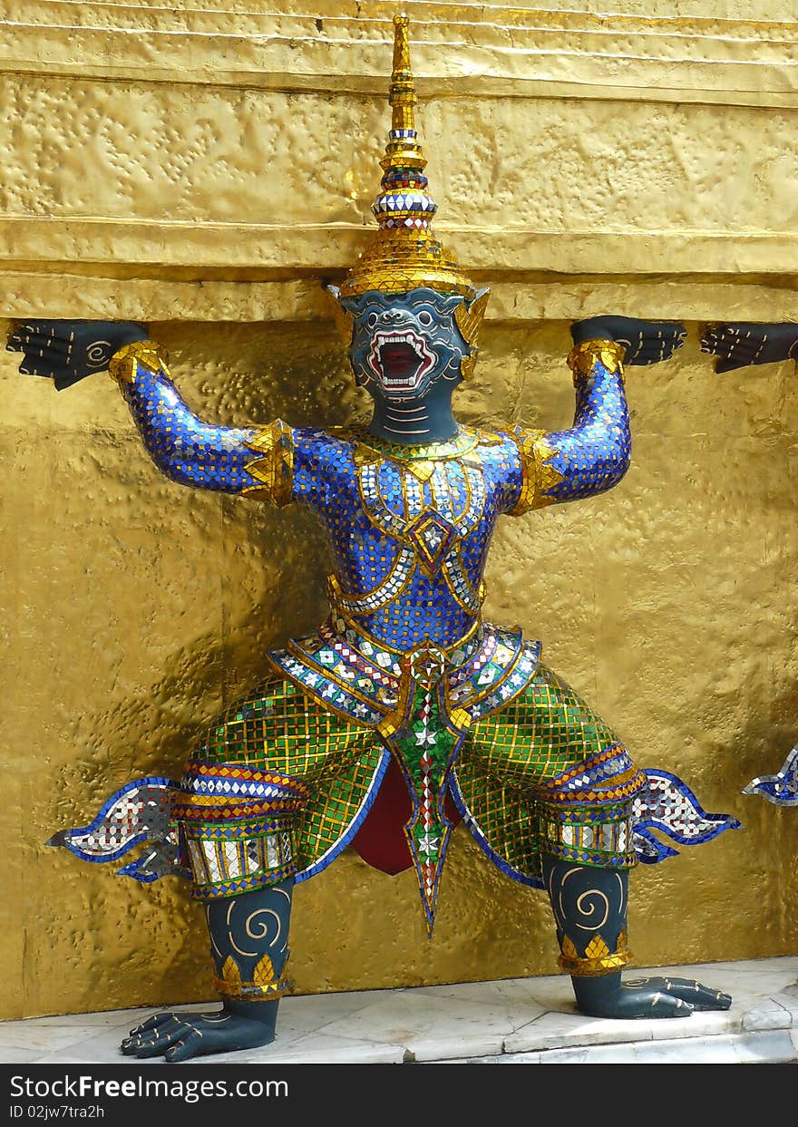 Old guardian statue in Bangkok temple, detail