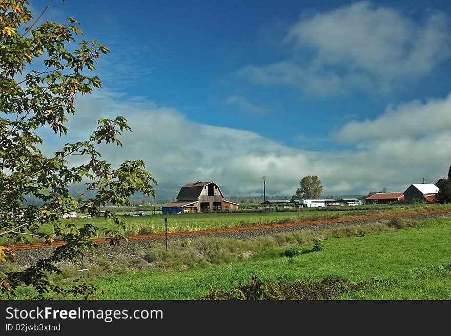 A barn and several outbuildings make up a 
farm scene