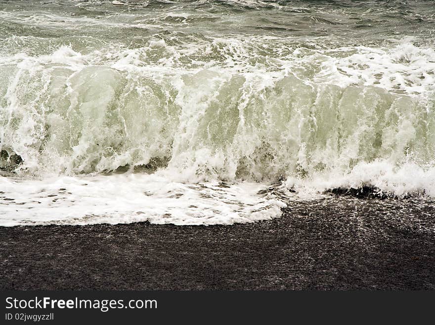 Heavy waves with white wave crest in storm at the beach from Janubio, a volcanic black beach, Lanzarote, Spain