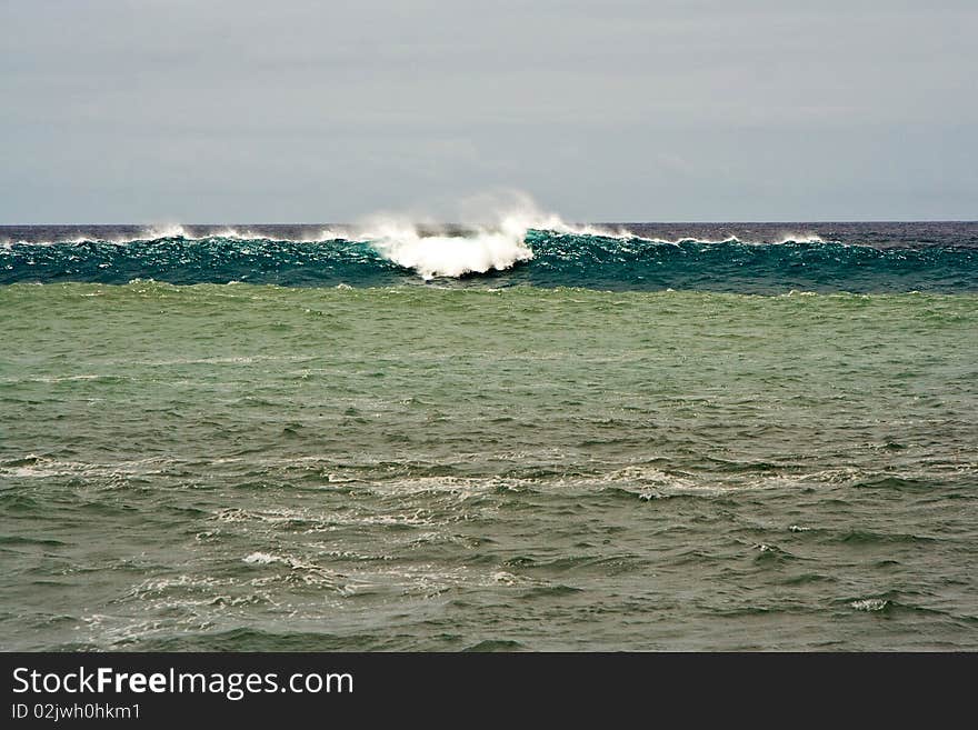 Heavy waves with white wave crest in storm at the beach from Janubio, a volcanic black beach, Lanzarote, Spain