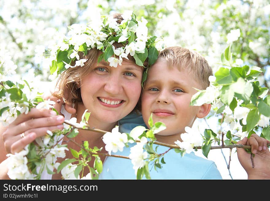 Portrait of Beautiful Happy mother with her son in the spring garden