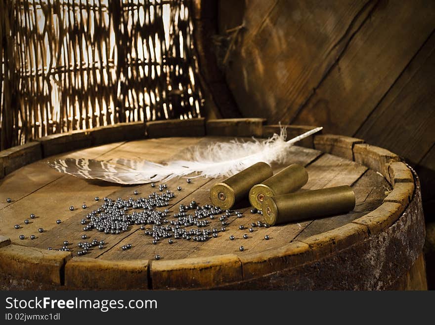 Shotgun shells and shot on wood background