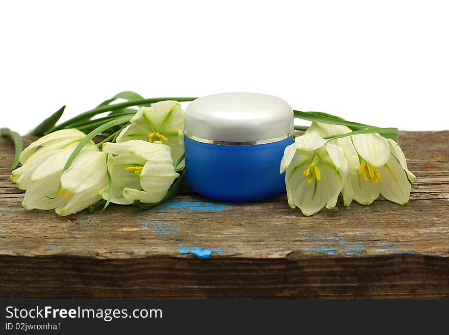 Spa cosmetic bottle, flower and wooden board isolated on white background