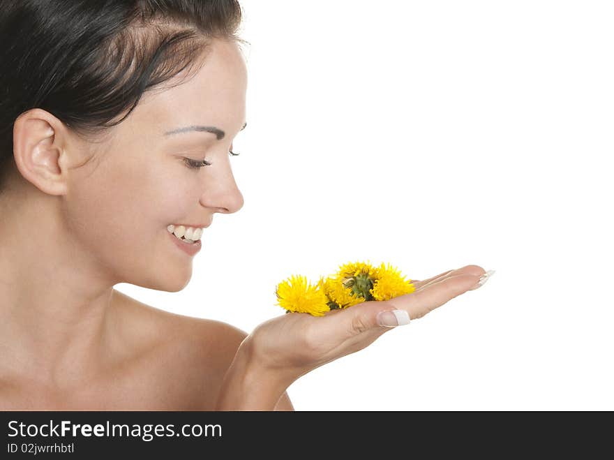 Smiling woman holds yellow flowers on palm