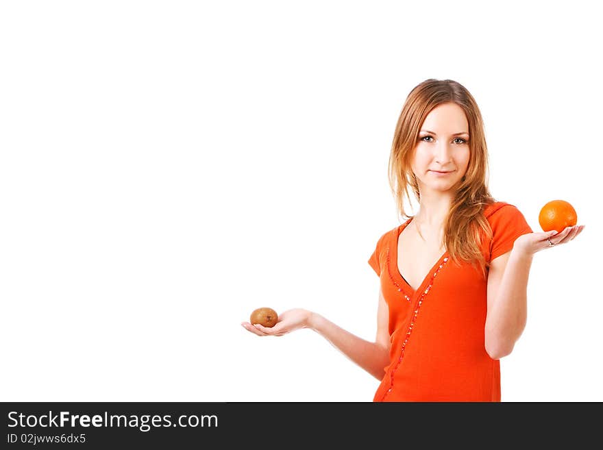 Picture of a young pretty girl in dress which holds orange and kiwi in different hands. Isolated on white. Picture of a young pretty girl in dress which holds orange and kiwi in different hands. Isolated on white.