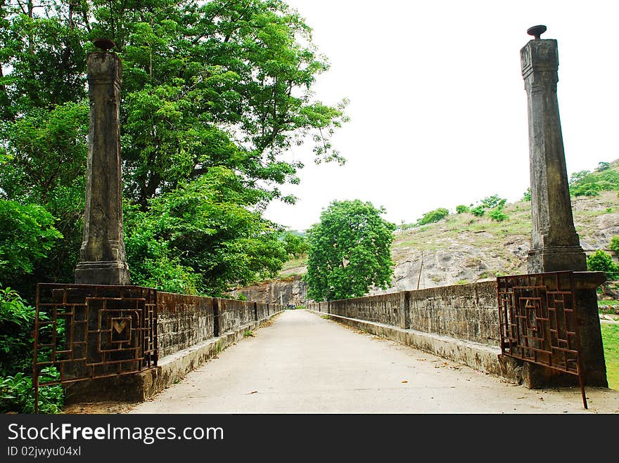 An old British footbridge on a river in Southern India. An old British footbridge on a river in Southern India