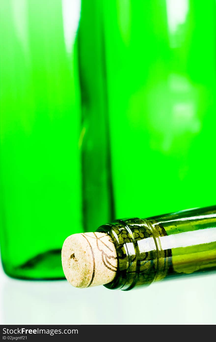 Green wine bottles on white background