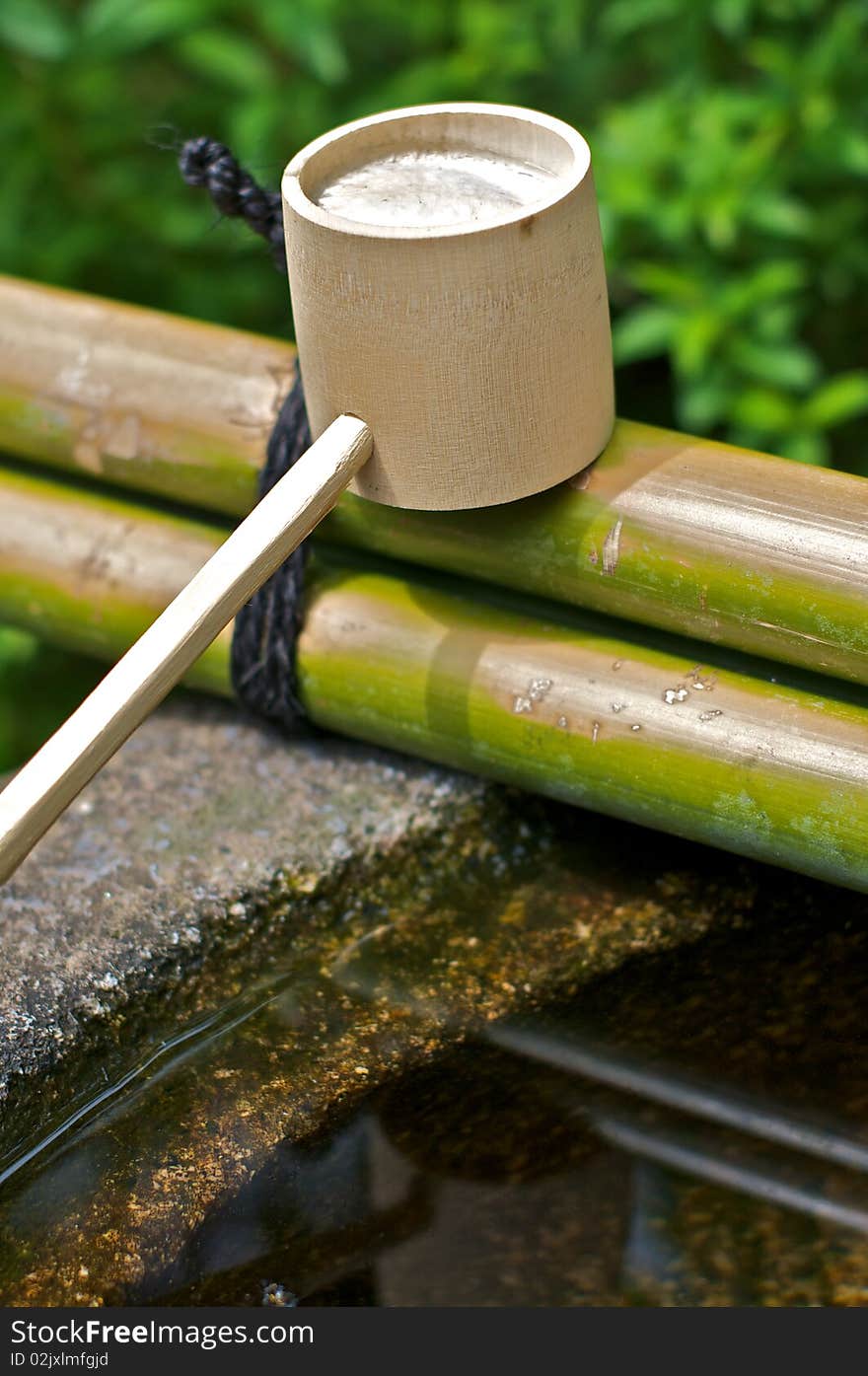 A cup for a bamboo fountain used for cleaning and purification in a Shinto temple. A cup for a bamboo fountain used for cleaning and purification in a Shinto temple.