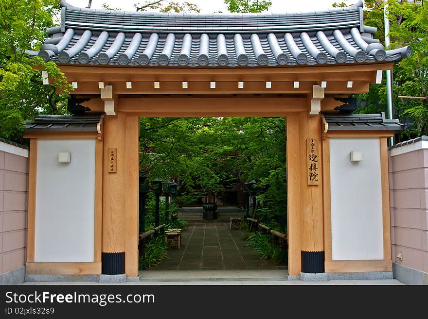 The exterior of a Shinto temple with light colored wood walls. The exterior of a Shinto temple with light colored wood walls