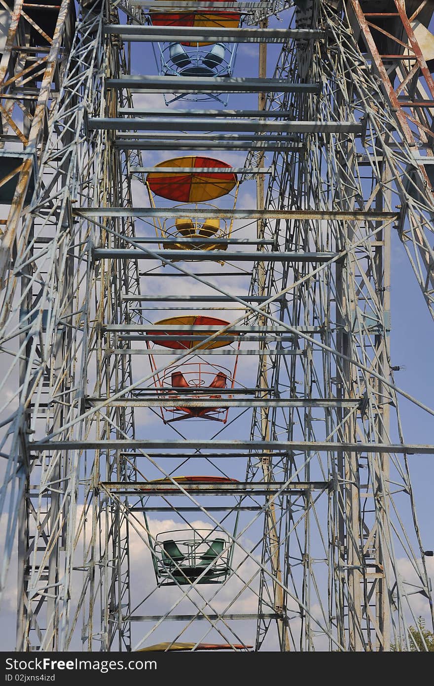 Old ferris wheel against blue sky