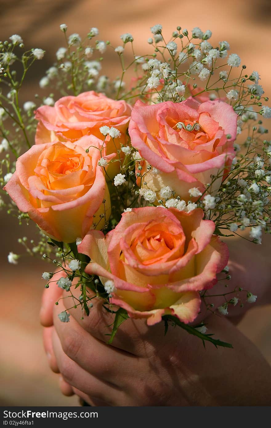 Wedding bouquet in hands of the groom. Wedding bouquet in hands of the groom