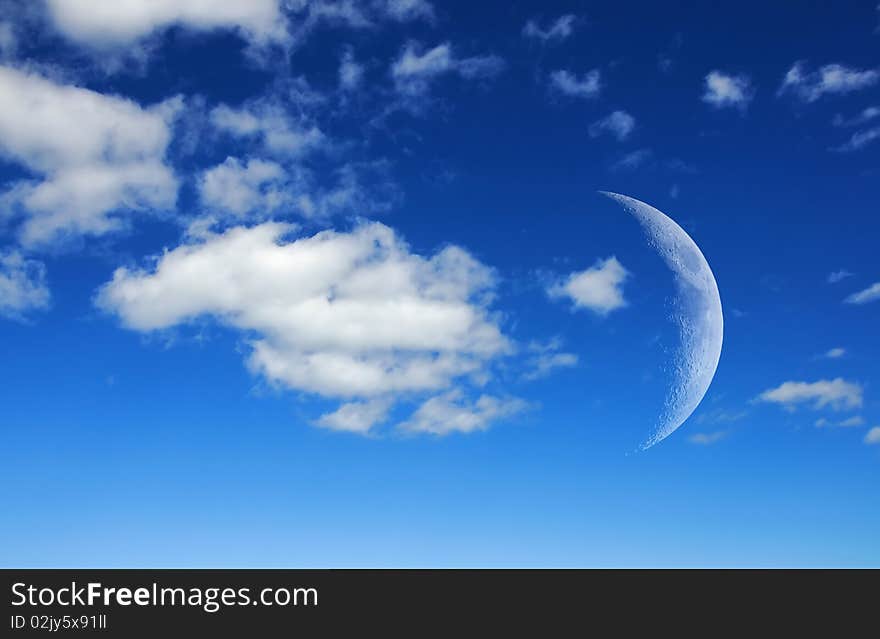 The satellite of our planet - the moon in a blue sky