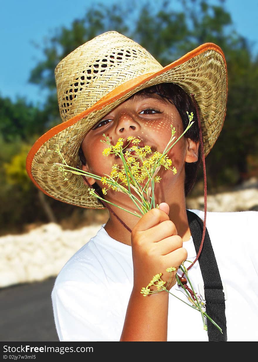 Portrait of a happy young beautiful boy smelling flowers. Portrait of a happy young beautiful boy smelling flowers