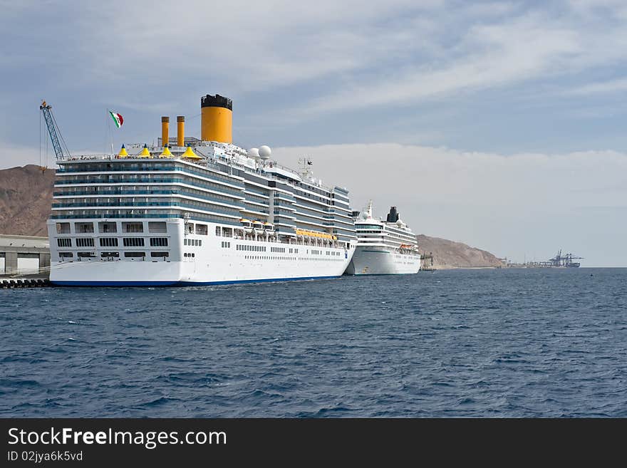 Giant Cruise Ships Moored At A Dock.