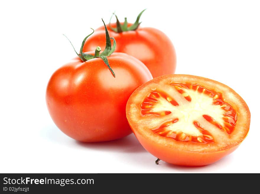 Red tomato vegetables with a half isolated on white background