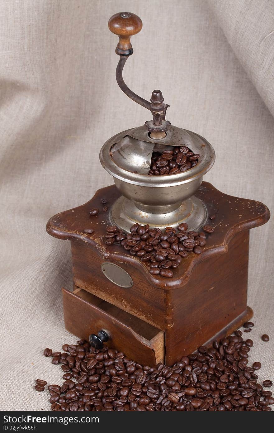 Antique coffee grinder with fried beans