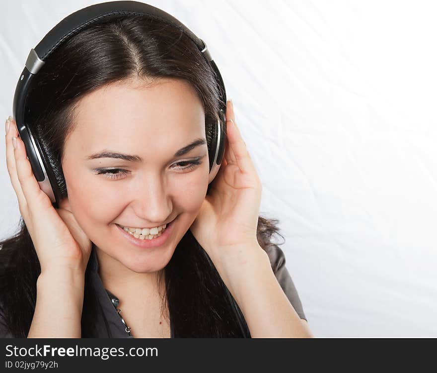 Studio portrait of happy beautiful girl listening music