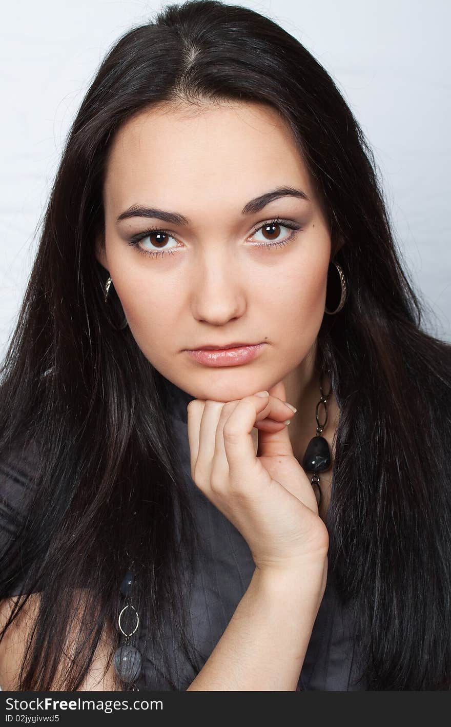 Studio portrait of attractive girl wearing beads