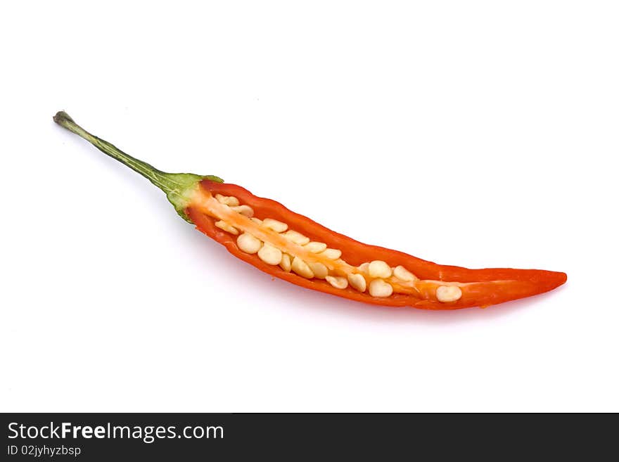 Cut open red birds eye chilli on a white background. Cut open red birds eye chilli on a white background