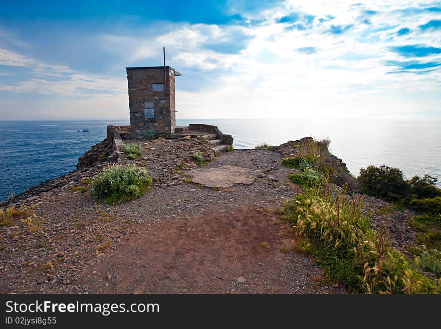 The rocky promontory of Punta Chiappa on a cloudy day after the storm. A point of watching the sea. The rocky promontory of Punta Chiappa on a cloudy day after the storm. A point of watching the sea