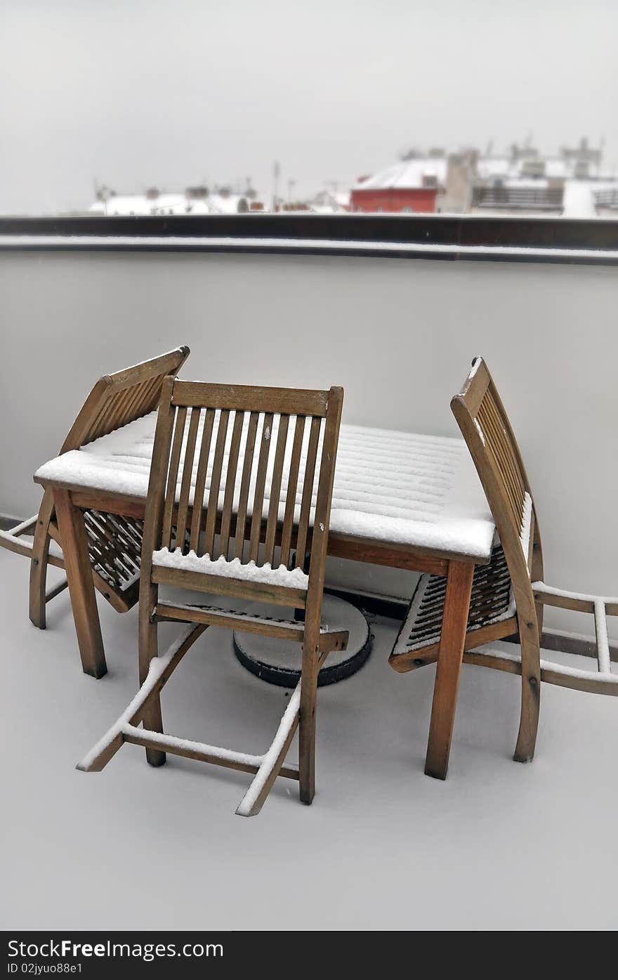 Snowy empty table and chairs on Prague winter terrace, Czech Republic. Snowy empty table and chairs on Prague winter terrace, Czech Republic