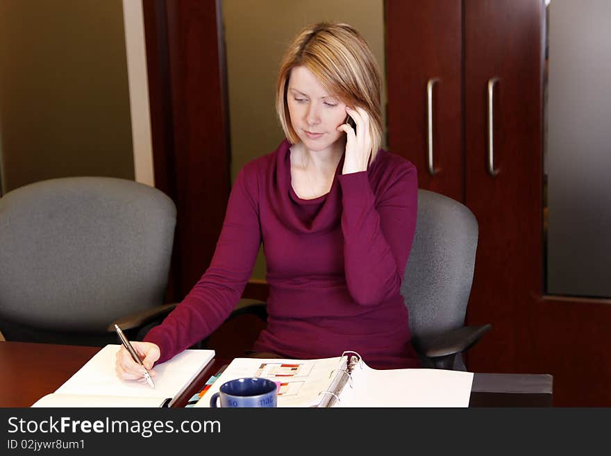 A young business person working in boardroom. A young business person working in boardroom.