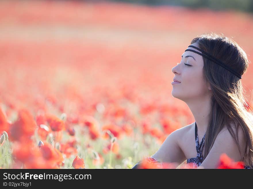 Young girl in poppies field