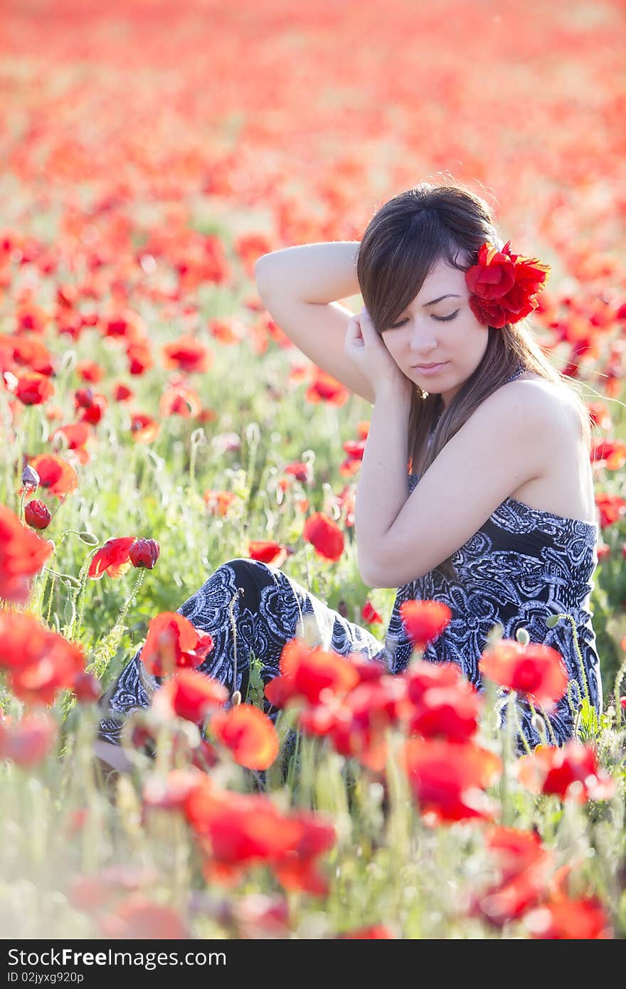 Young girl in poppies field