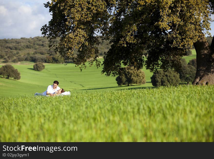 Young couple enjoying outdoors on nature. Young couple enjoying outdoors on nature.