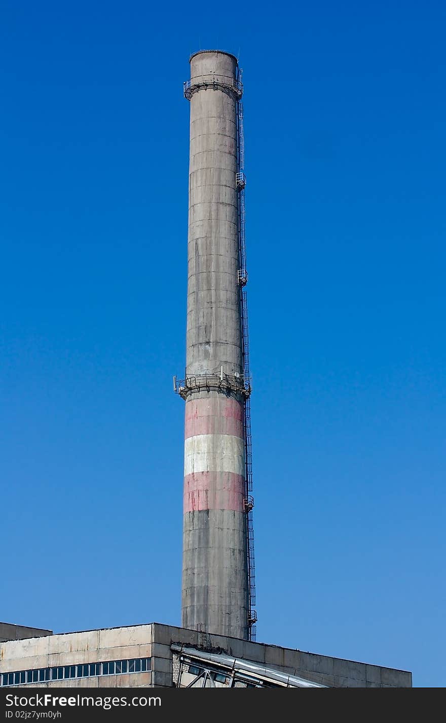 Chimney pipe against the blue sky