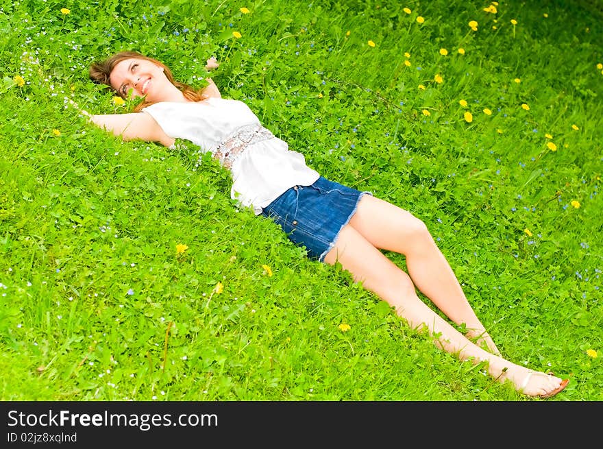 Pretty girl lying on grass